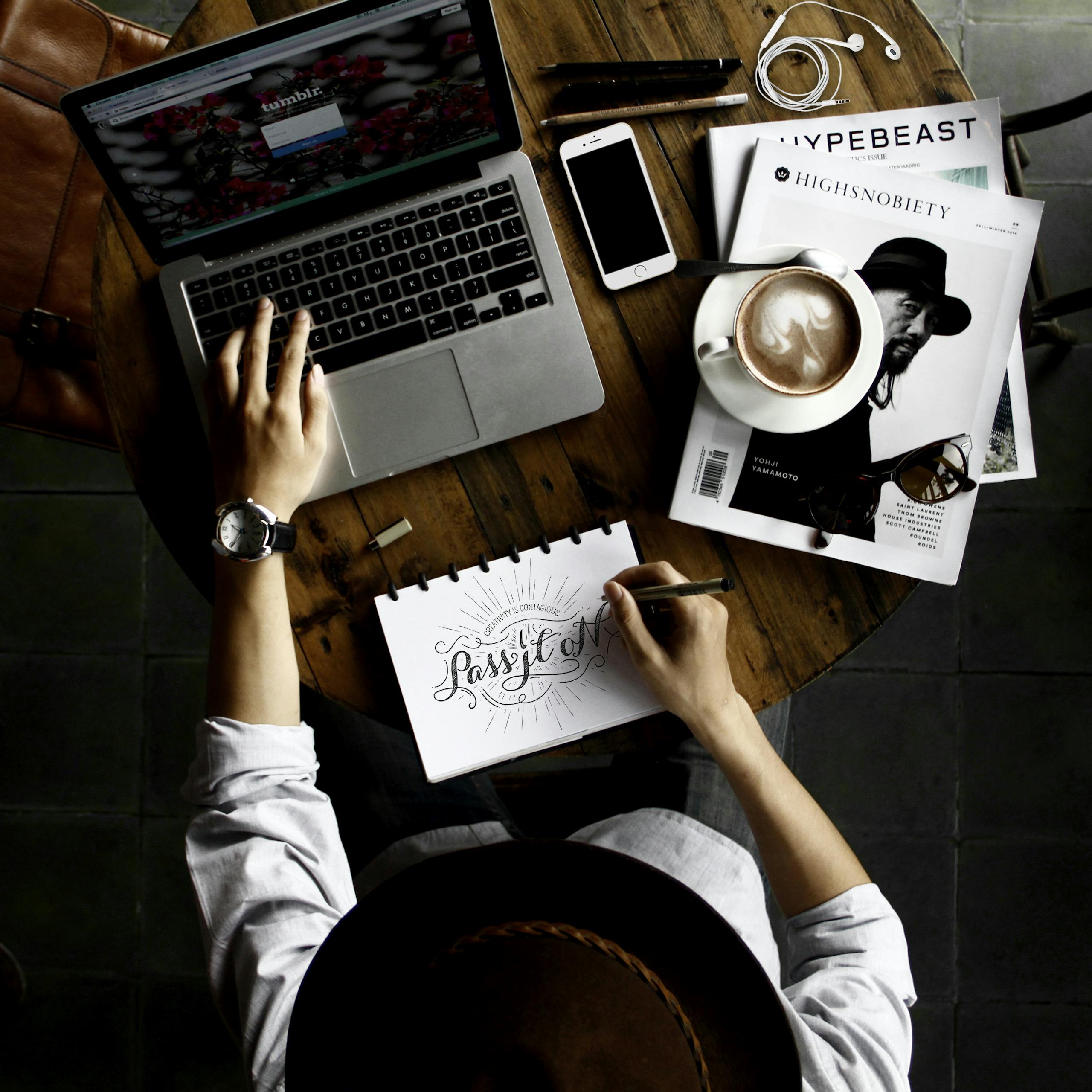 Person Sitting Facing Laptop Computer With Sketch Pad