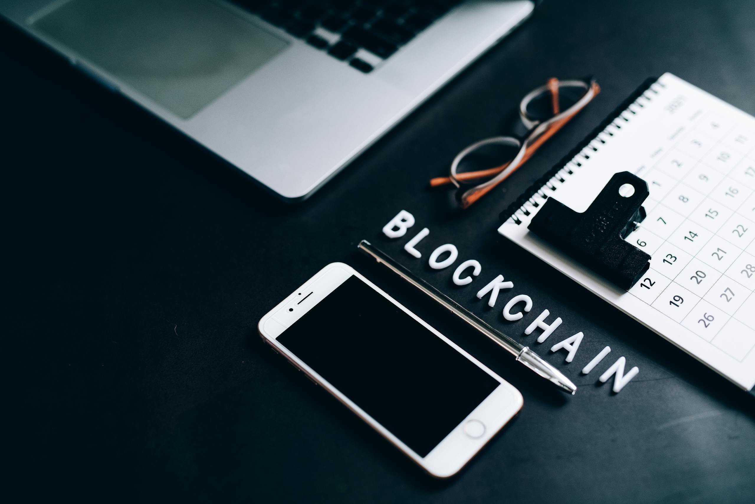 Smartphone, Pen, Calendar and Eyeglasses on Flat Surface