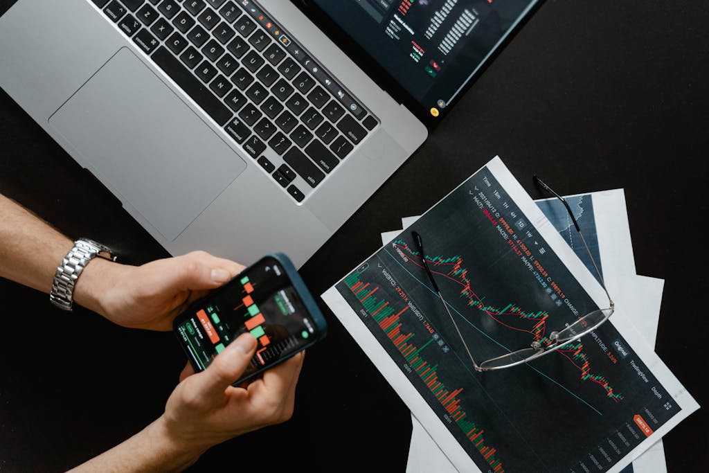 Hands Holding a Smartphone with Data on Screen