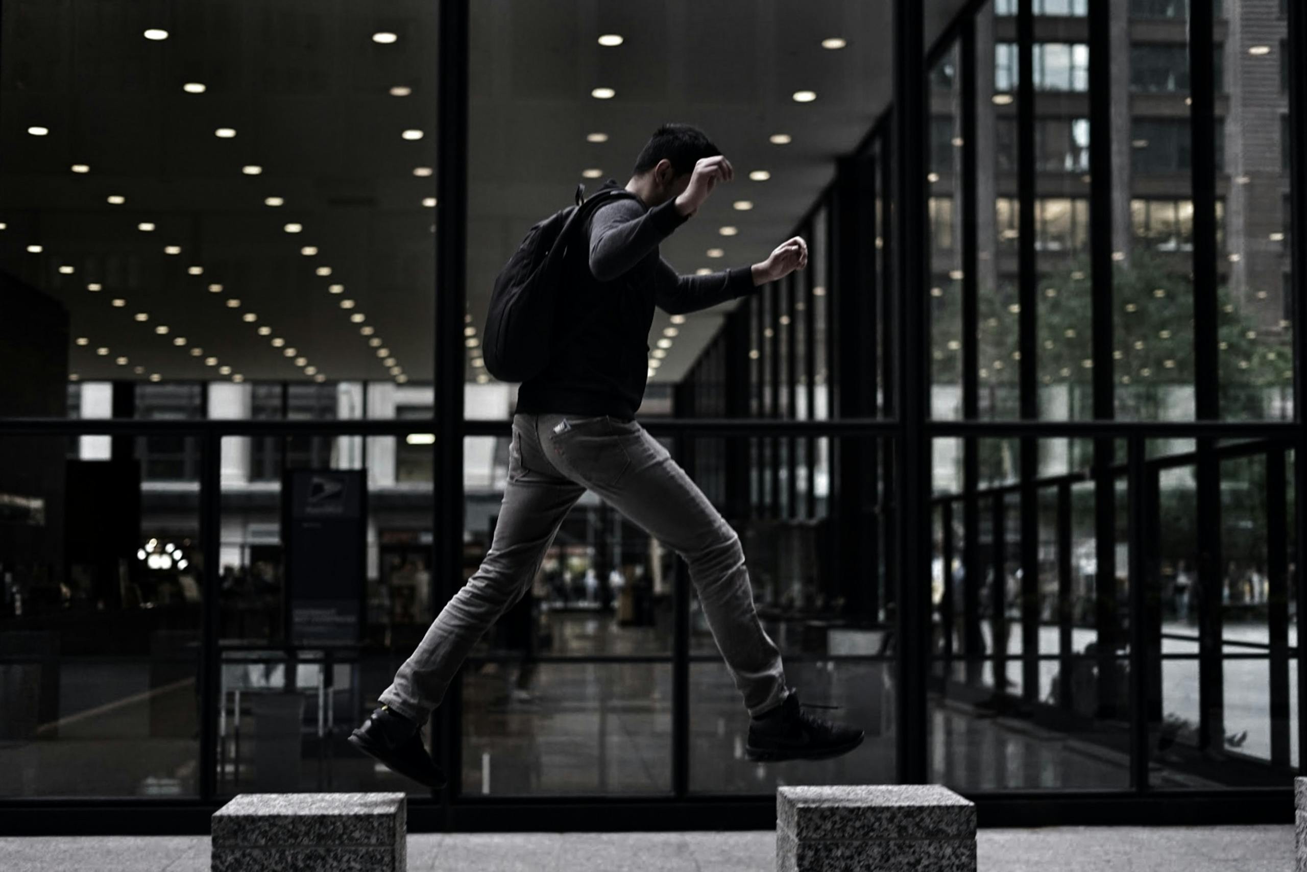 Unrecognizable man stepping onto concrete platform in modern style building