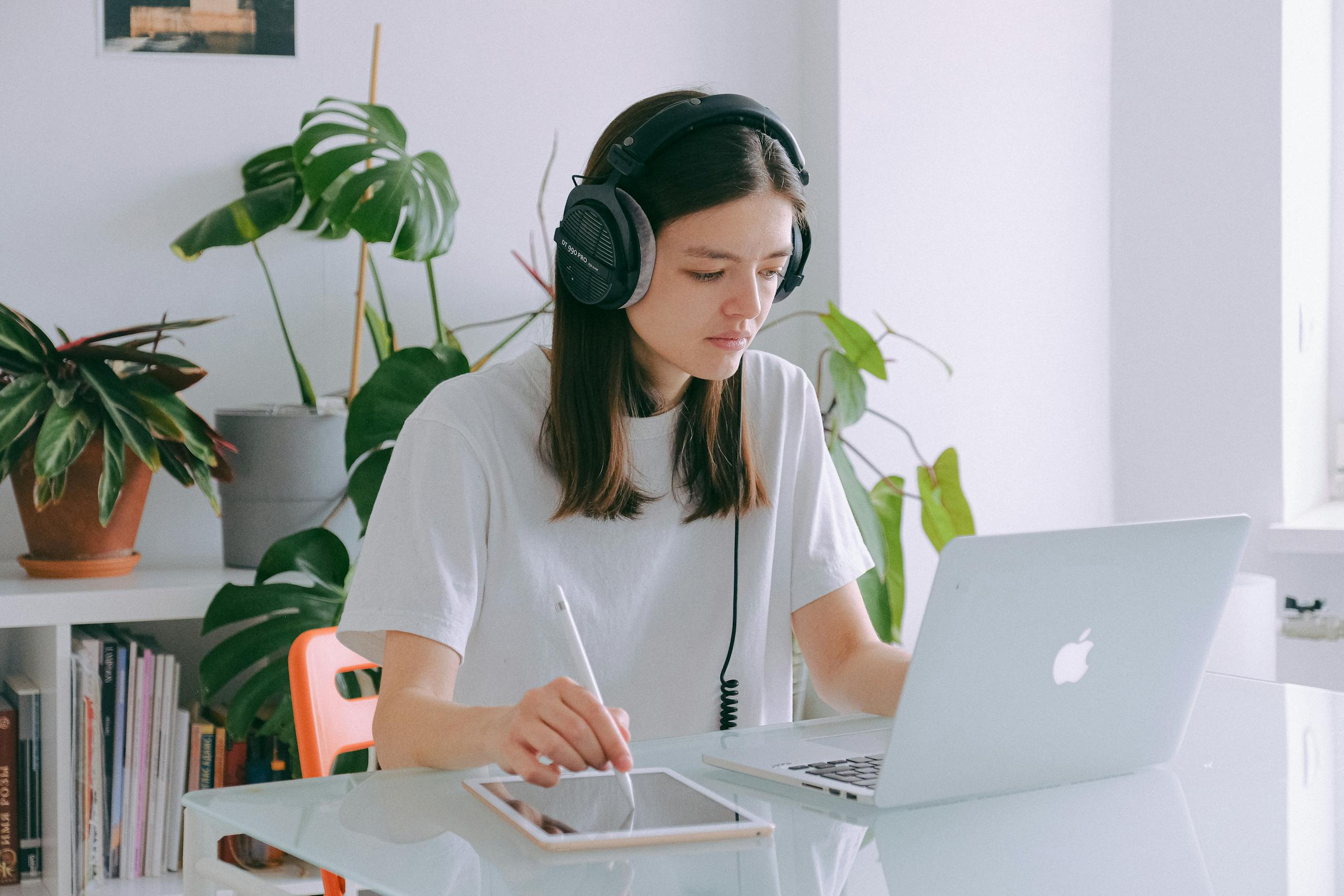 Woman In White Shirt Using Silver Macbook