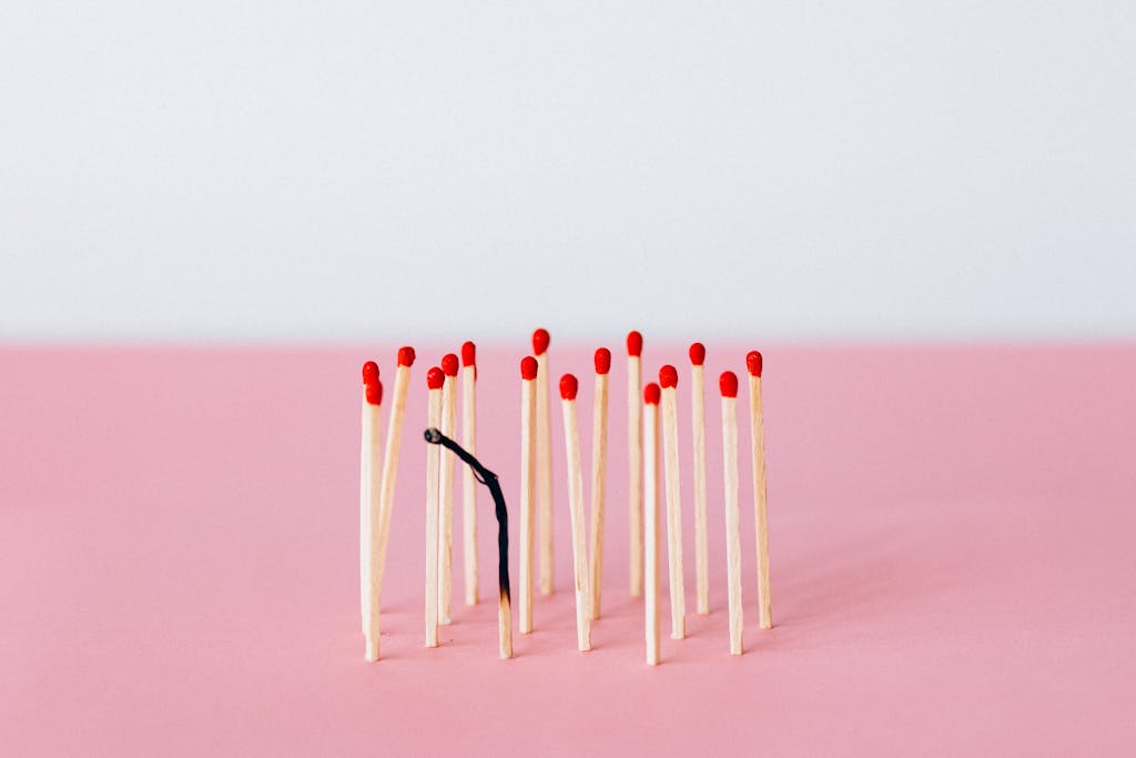 Matchsticks on Pink Surface