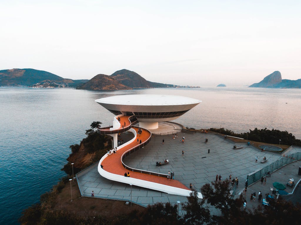 White Concrete Building Beside Body of Water